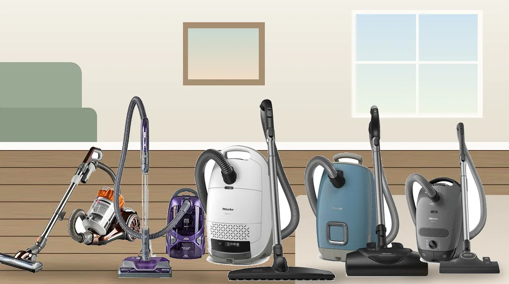 Five canister vacuums with hard floor tools standing on a hardwood floor in a bright living room