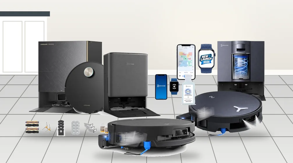 Three robot vacuum and mop combos with self-cleaning docks on a tiled kitchen floor