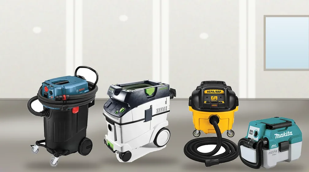 HEPA dust extractors and a cordless HEPA vac on a dusty floor in a room with new drywall